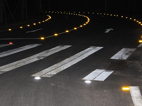 Solar-powered road studs sparkle at night